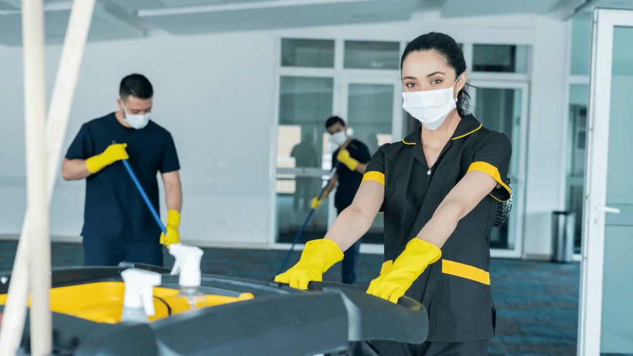 Professional cleaning staff in uniforms and masks providing commercial and residential hassle-free cleaning services.